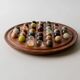 Vintage 1960s solitaire game, wooden board with stone marbles.
