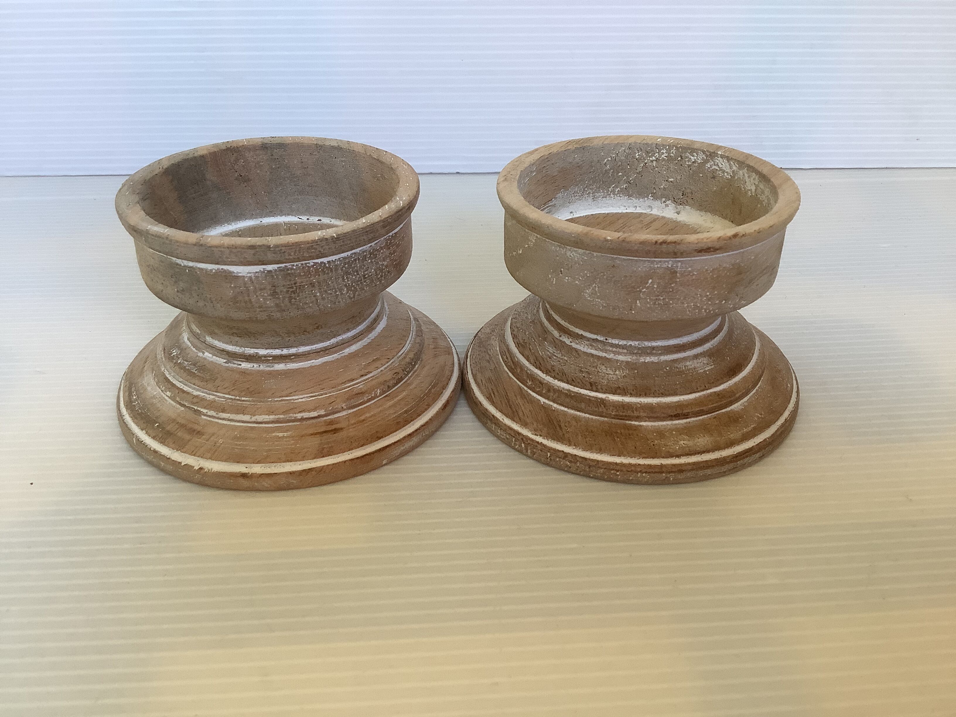 Pair of wooden candlesticks with a white effect