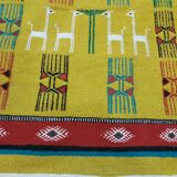 Mustard colored carpet with gazelle patterns berber style