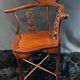 Corner armchair in solid wood with carved floral decoration featuring a bird.