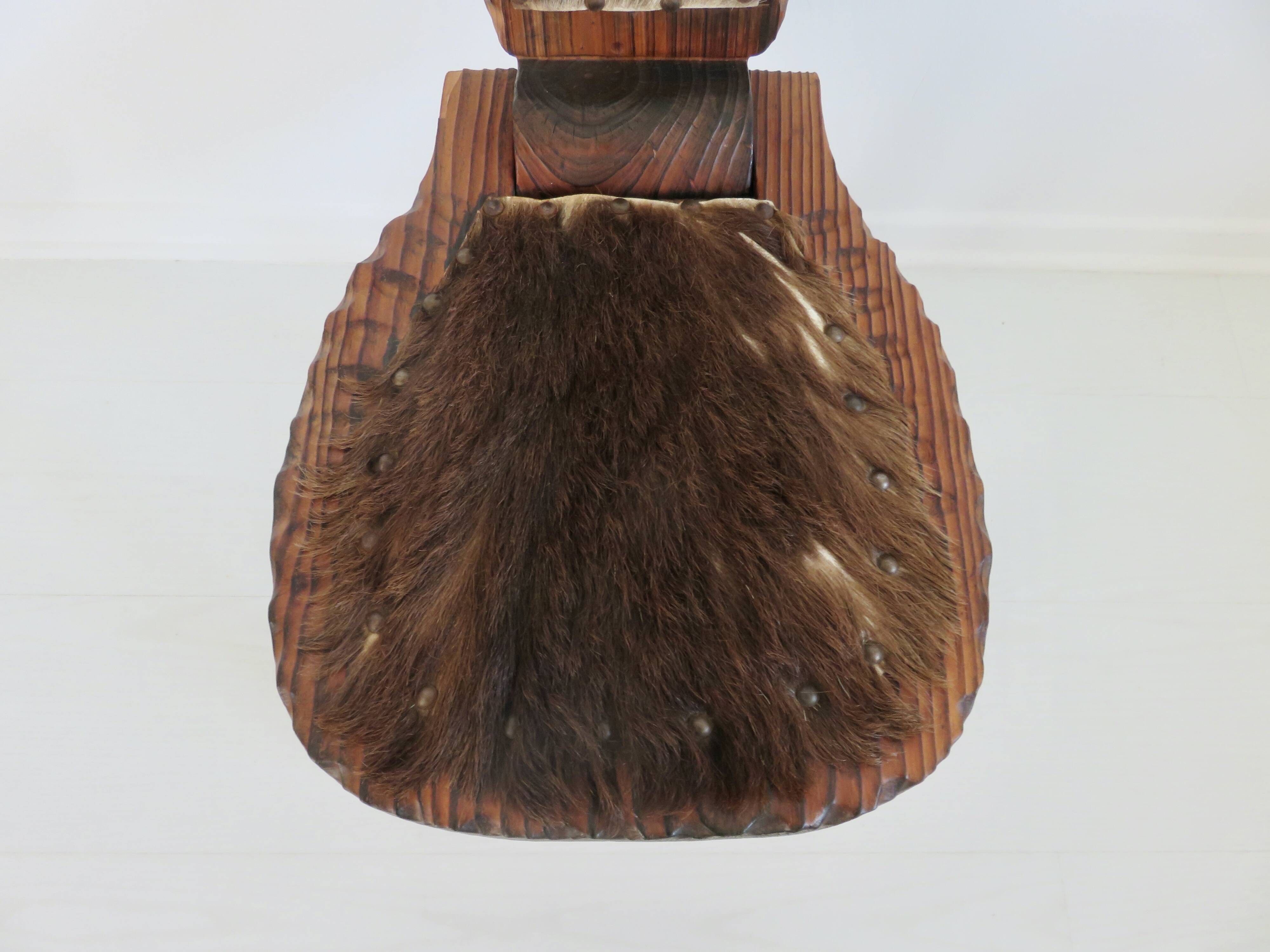 Brutalist cowhide tripod stool in solid wood