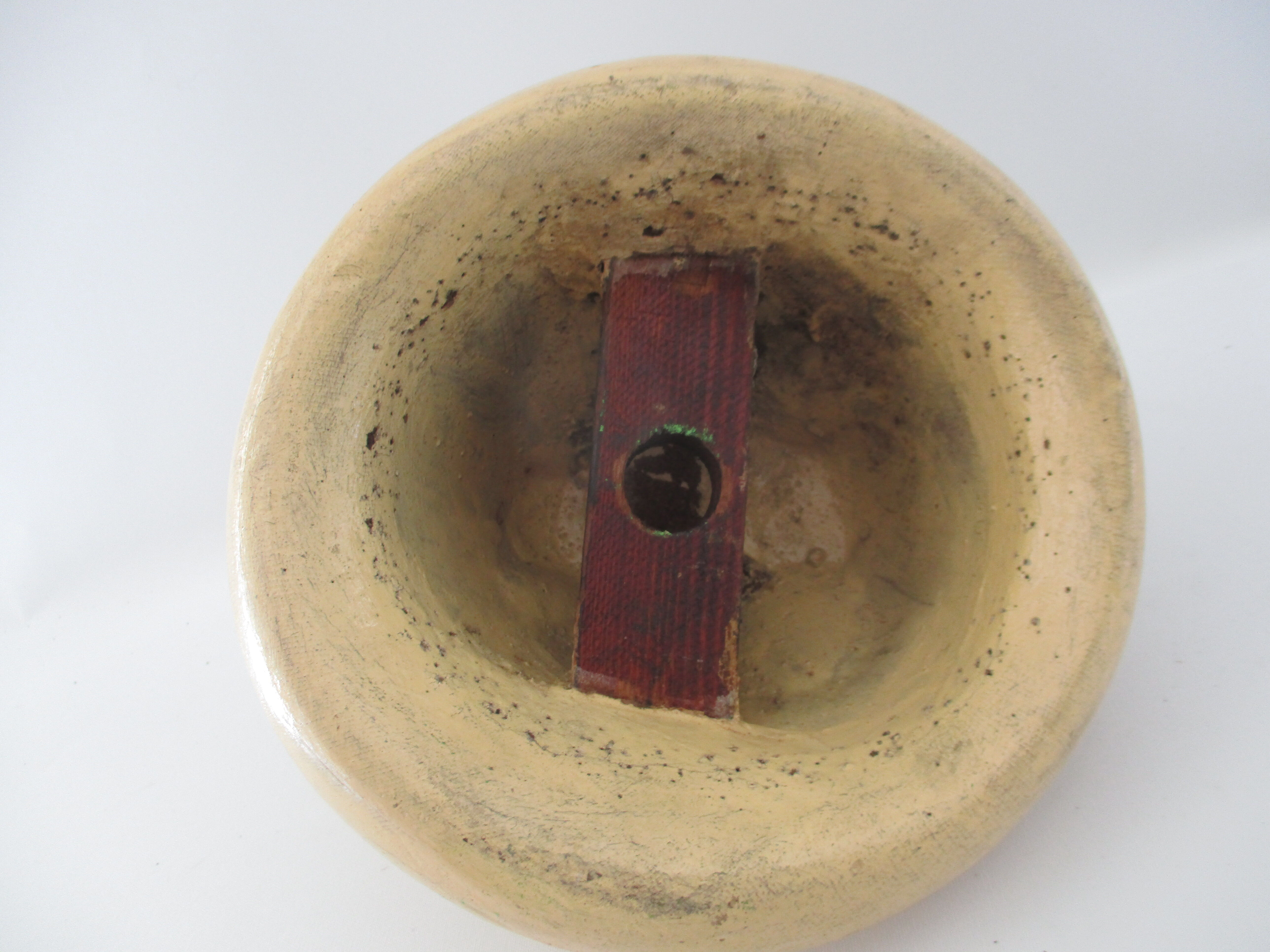 Shape of pressed plaster hat with surface and textile fiber of yellowish color,