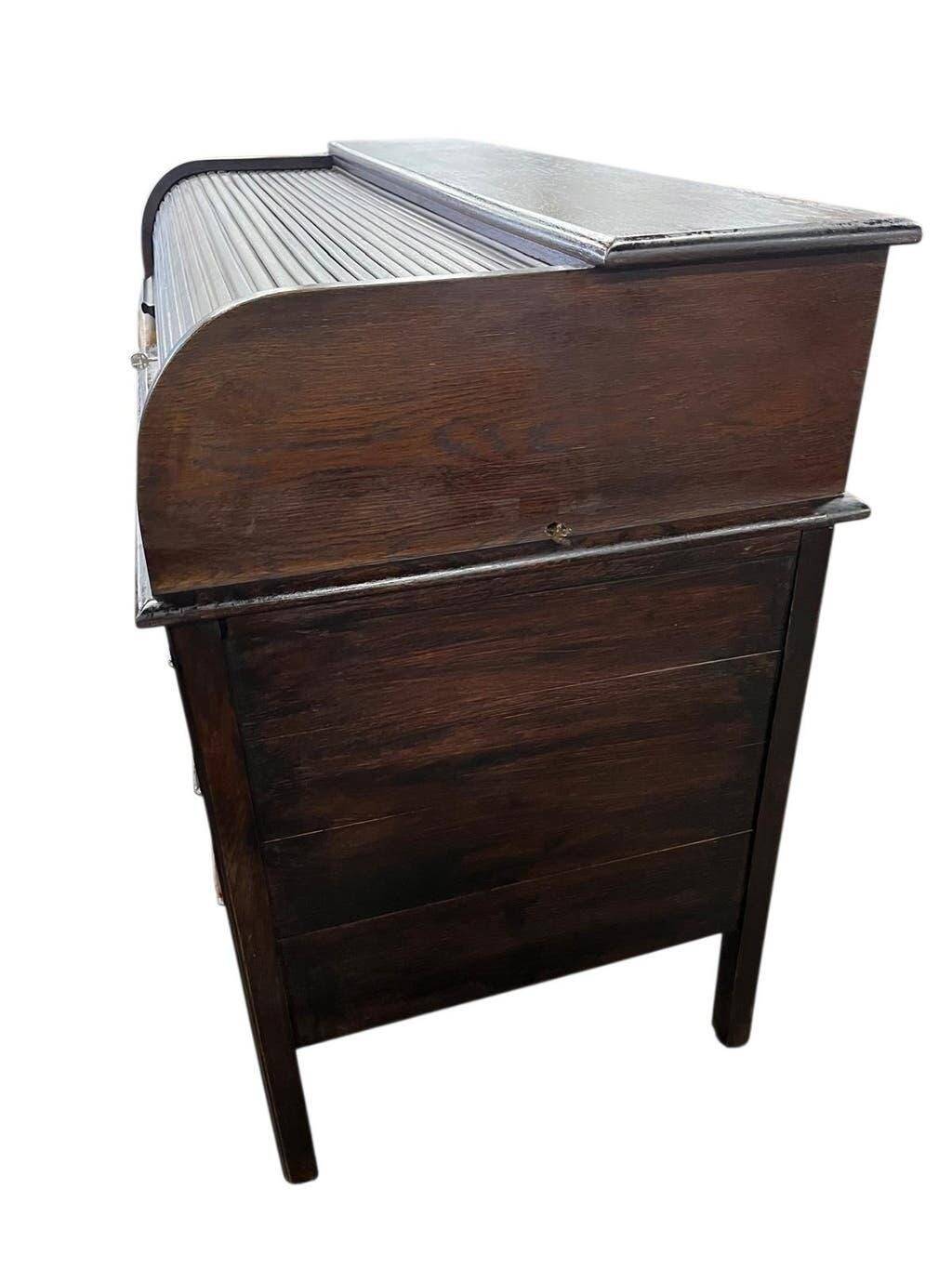 Vintage American wooden desk with a roll-top.