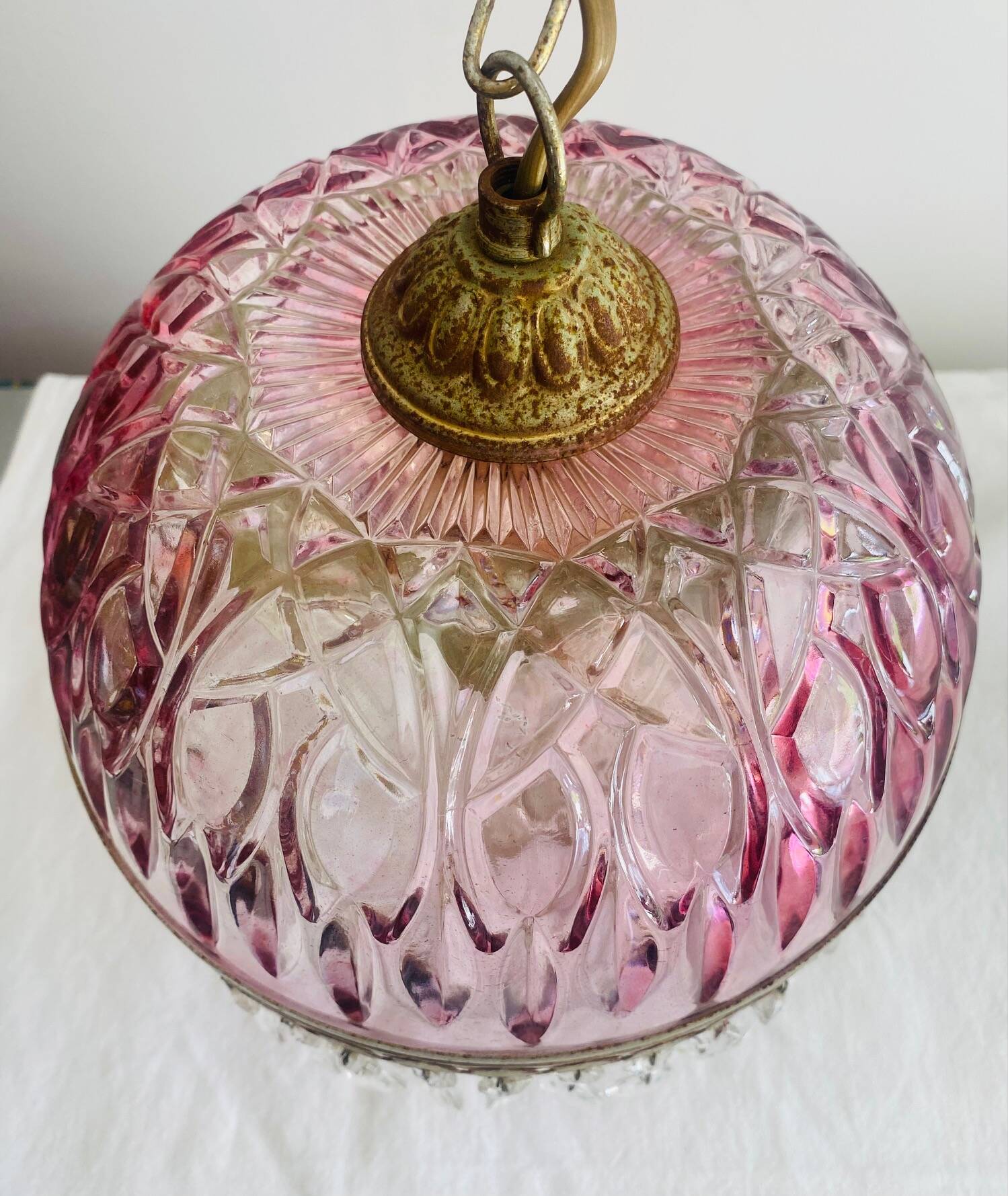 Antique pink glass pendant light with tassels.