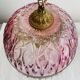Antique pink glass pendant light with tassels.