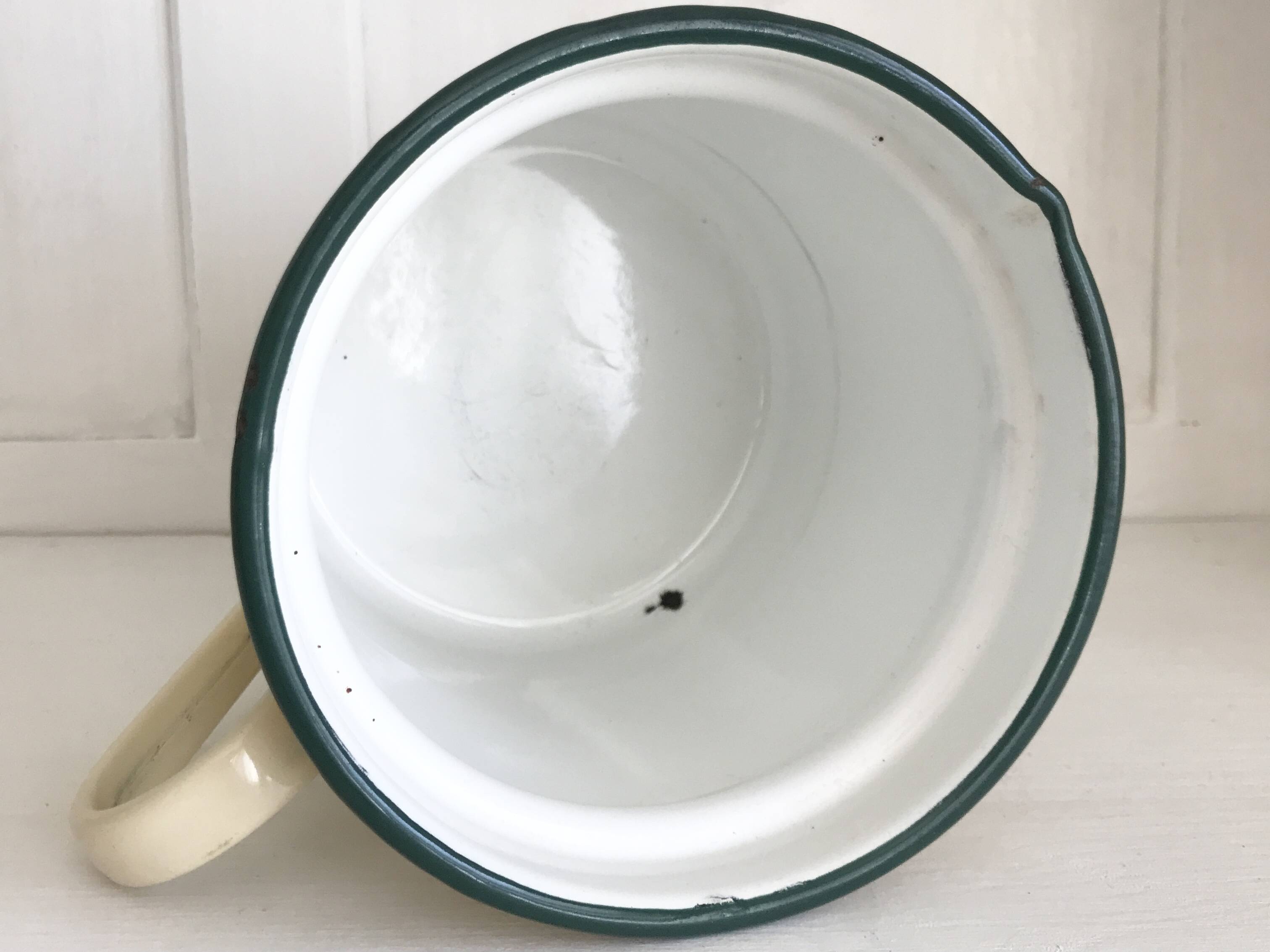 Old milk jug in enameled sheet metal