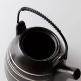 Vintage ceramic teapot from the 1980s, black with white stripes and a metal handle.
