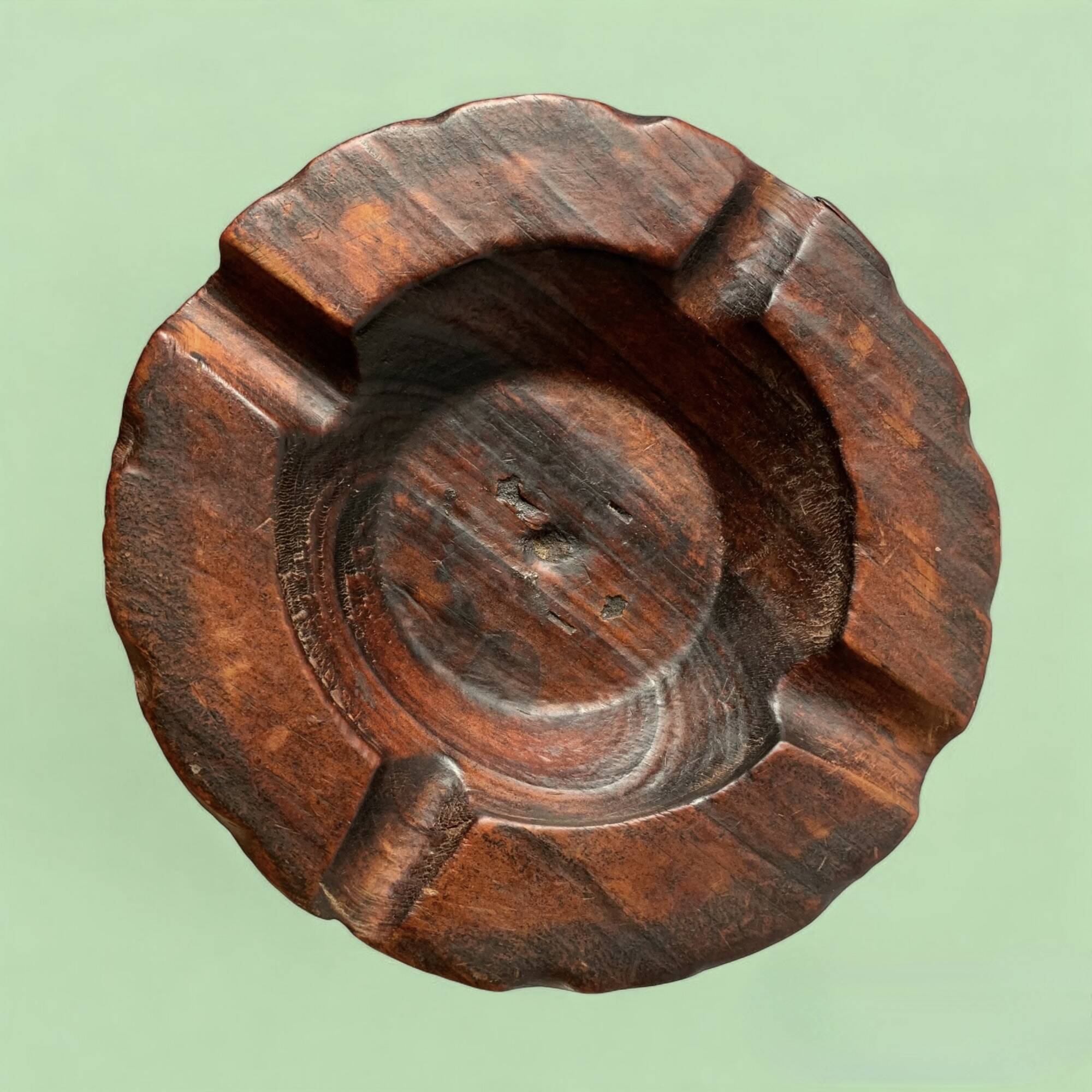 Old ashtray on carved wooden stand