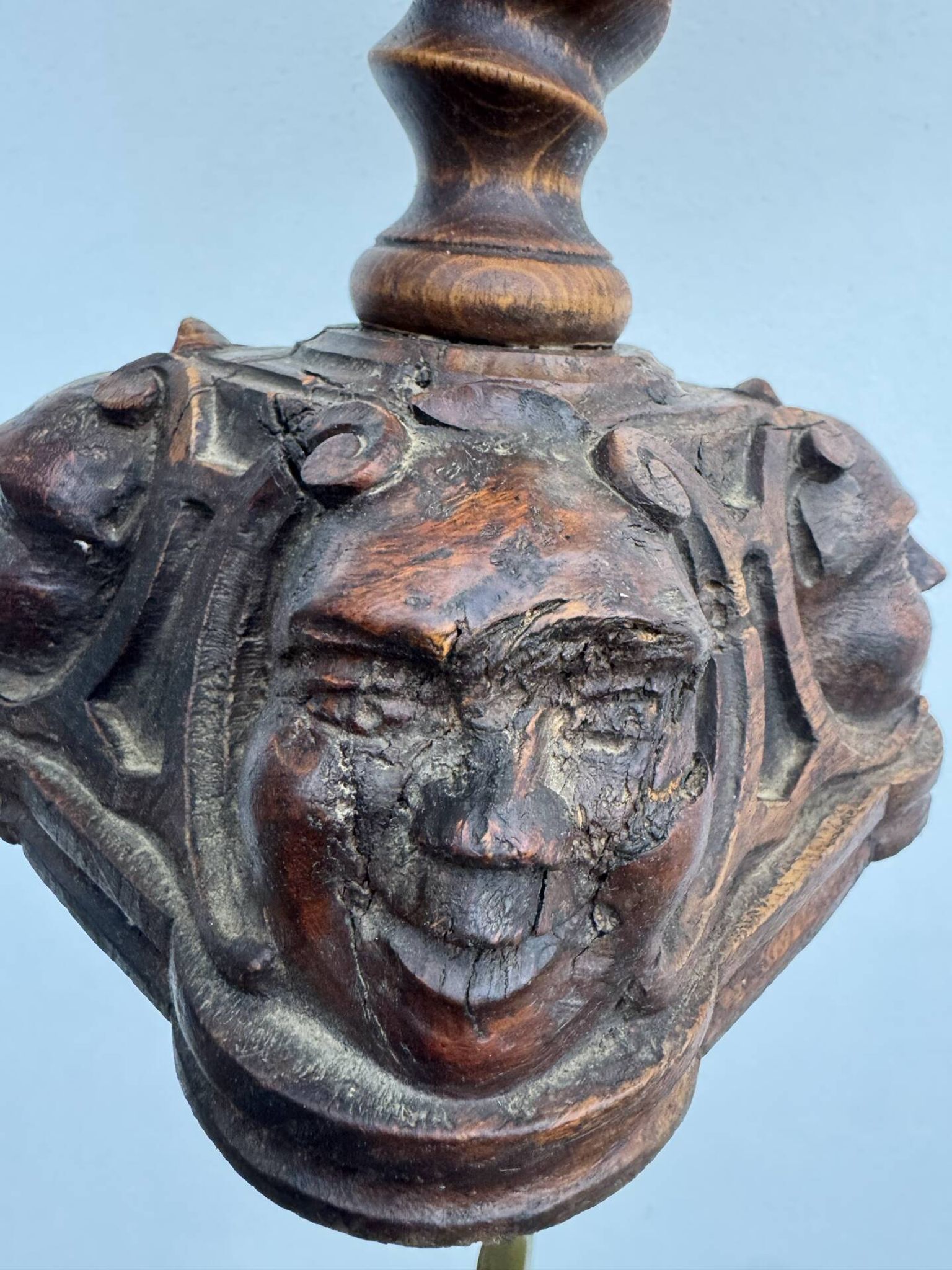 Sculpted wooden lamp with faces, antique.