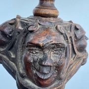 Sculpted wooden lamp with faces, antique.