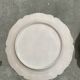 Antique plates from the late 19th century with scalloped edges and fruit decoration.