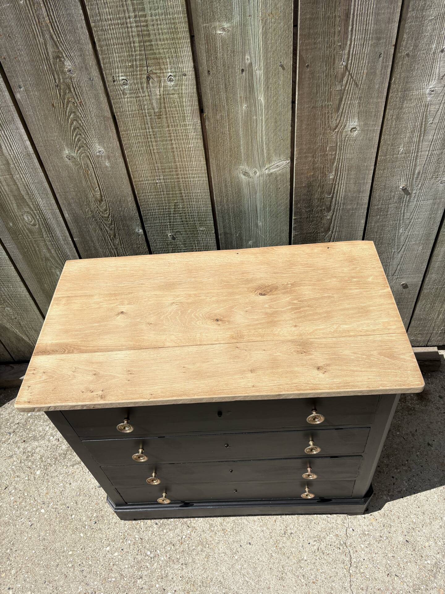 Antique commode with a matte black finish.