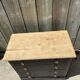 Antique commode with a matte black finish.