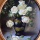 Large still life with white roses in an old gilded oval frame.