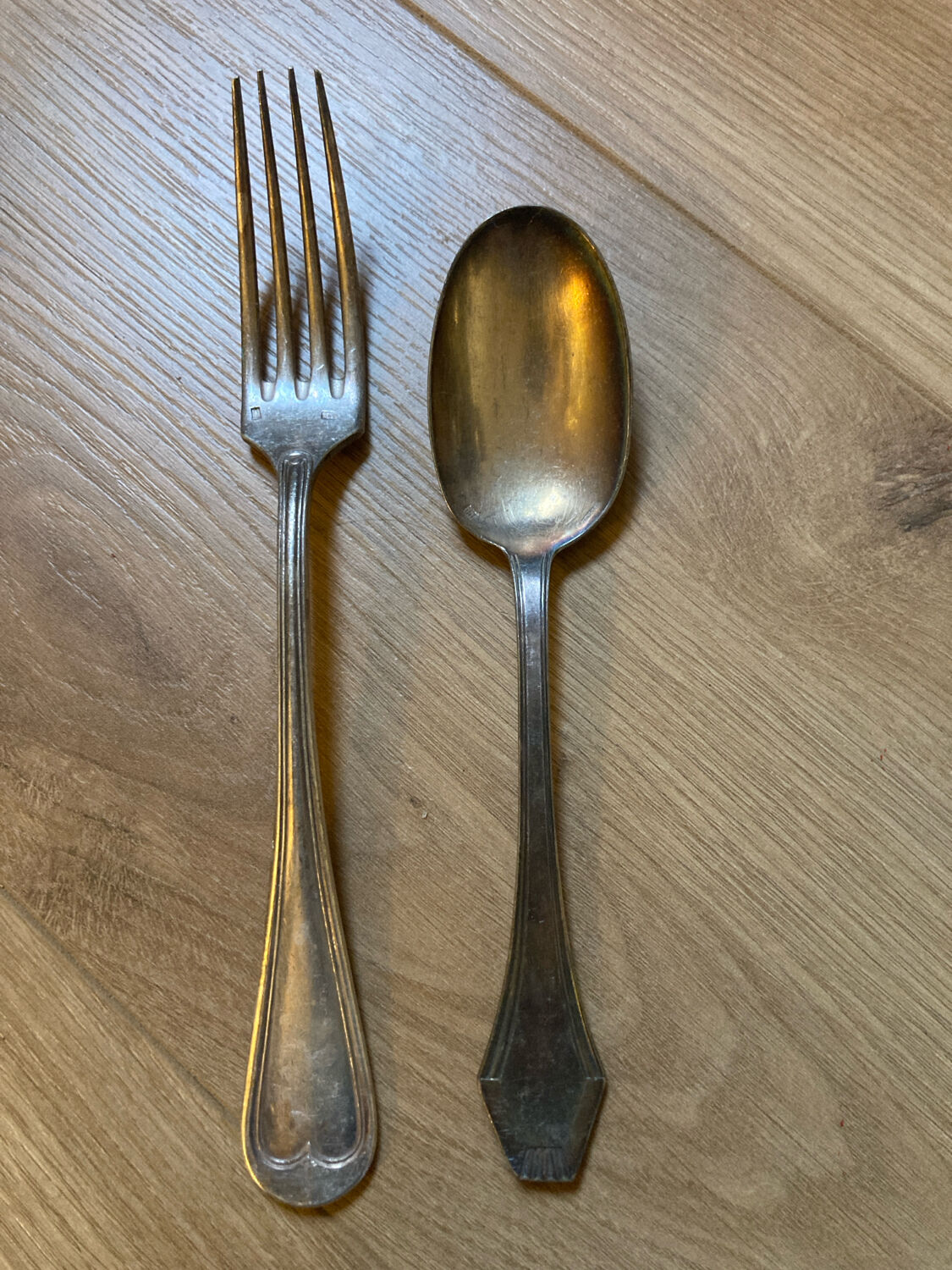 Two sets of silver-plated cutlery.