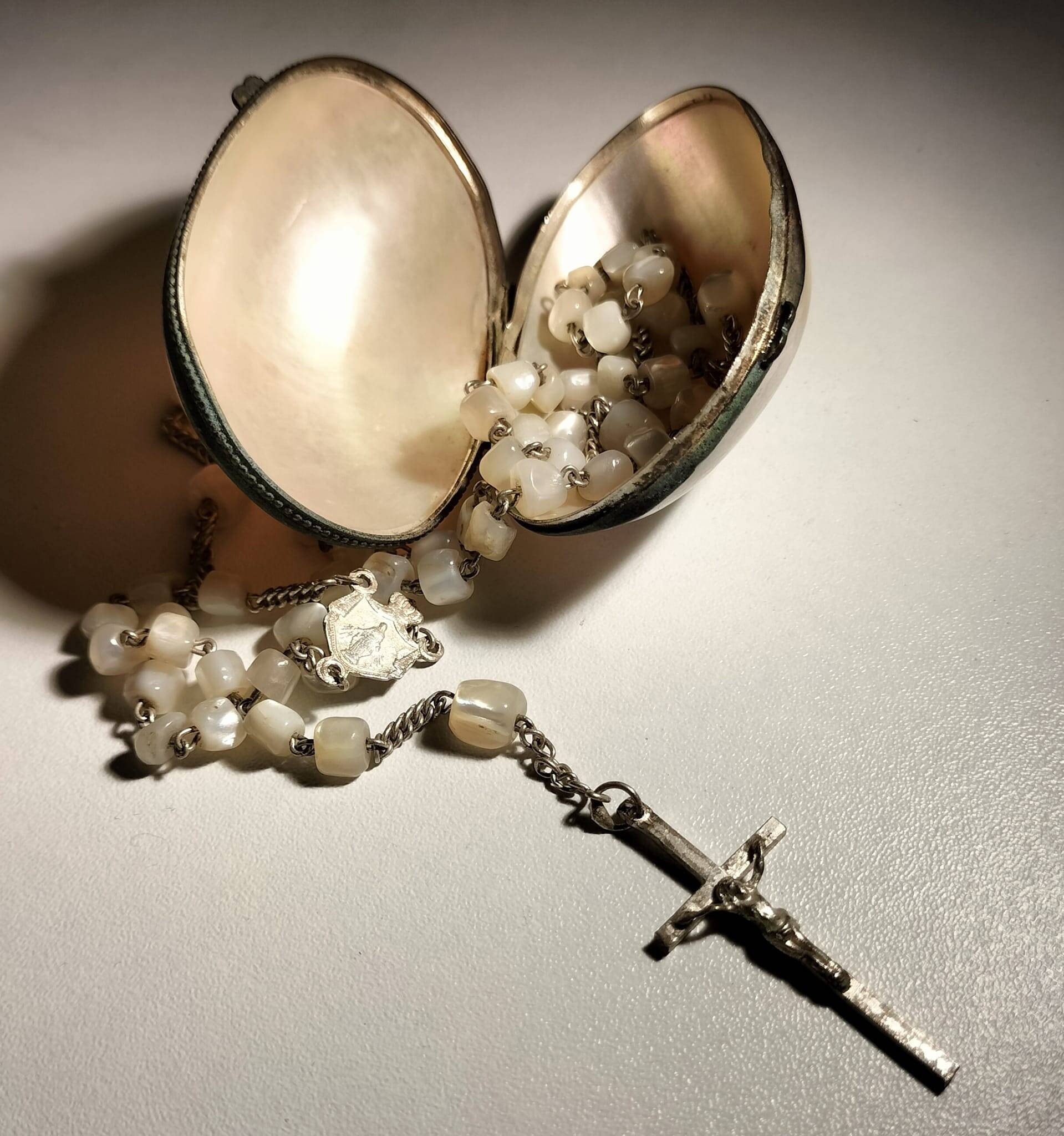 Old mother-of-pearl rosary in its egg box