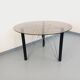 Vintage round dining table in smoked glass, black metal and chrome metal.