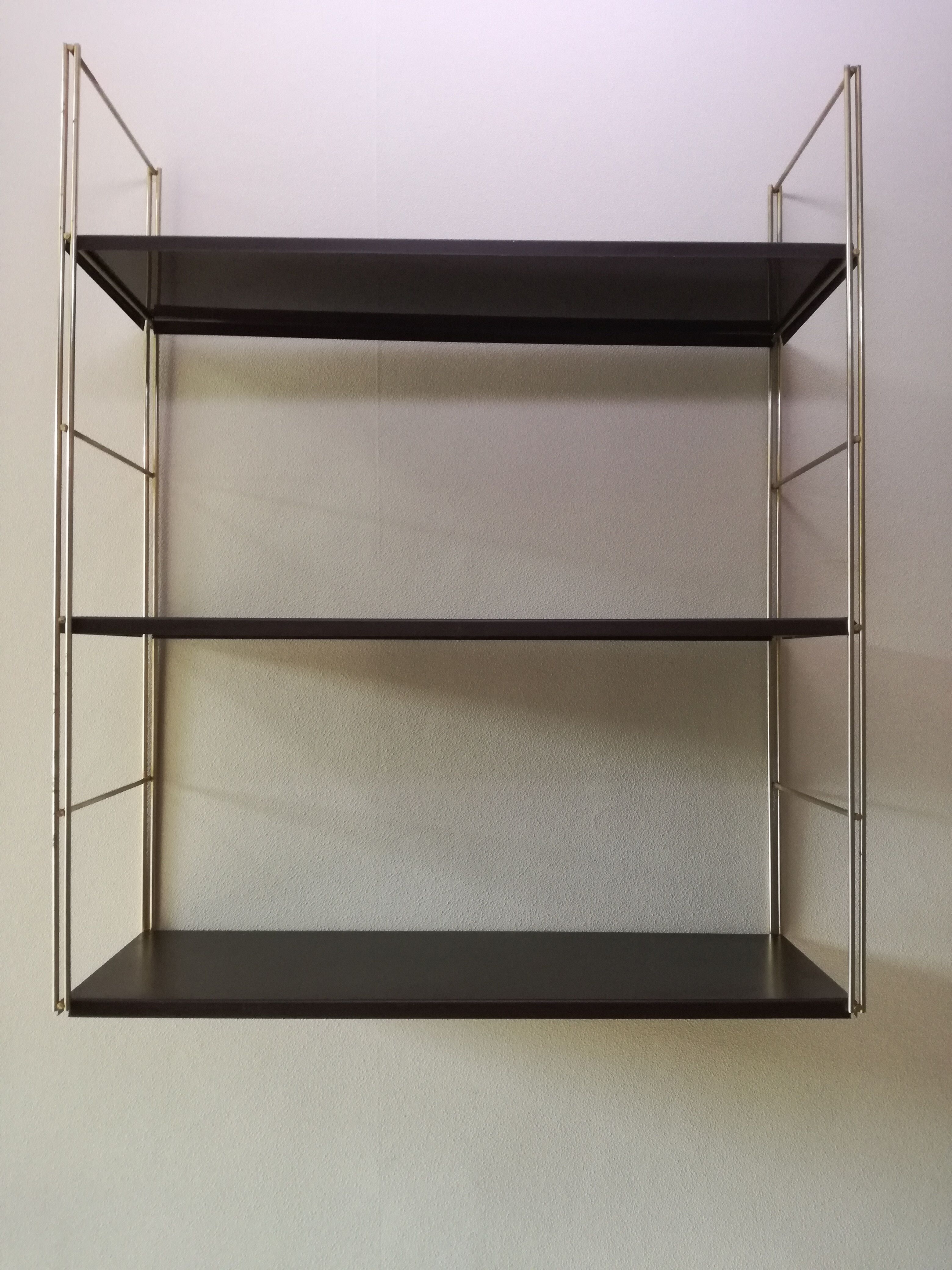 Golden and brown stringed shelf in metal