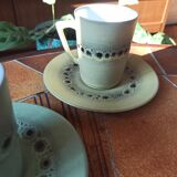 A pair of vintage glazed stoneware cups and saucers.