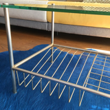 Glass coffee table with gold metal magazine holder