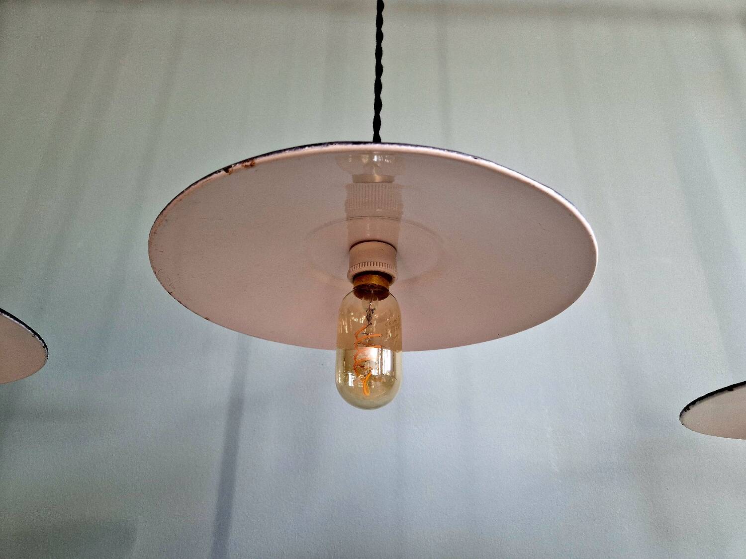 Three industrial suspensions in black enamelled sheet metal.