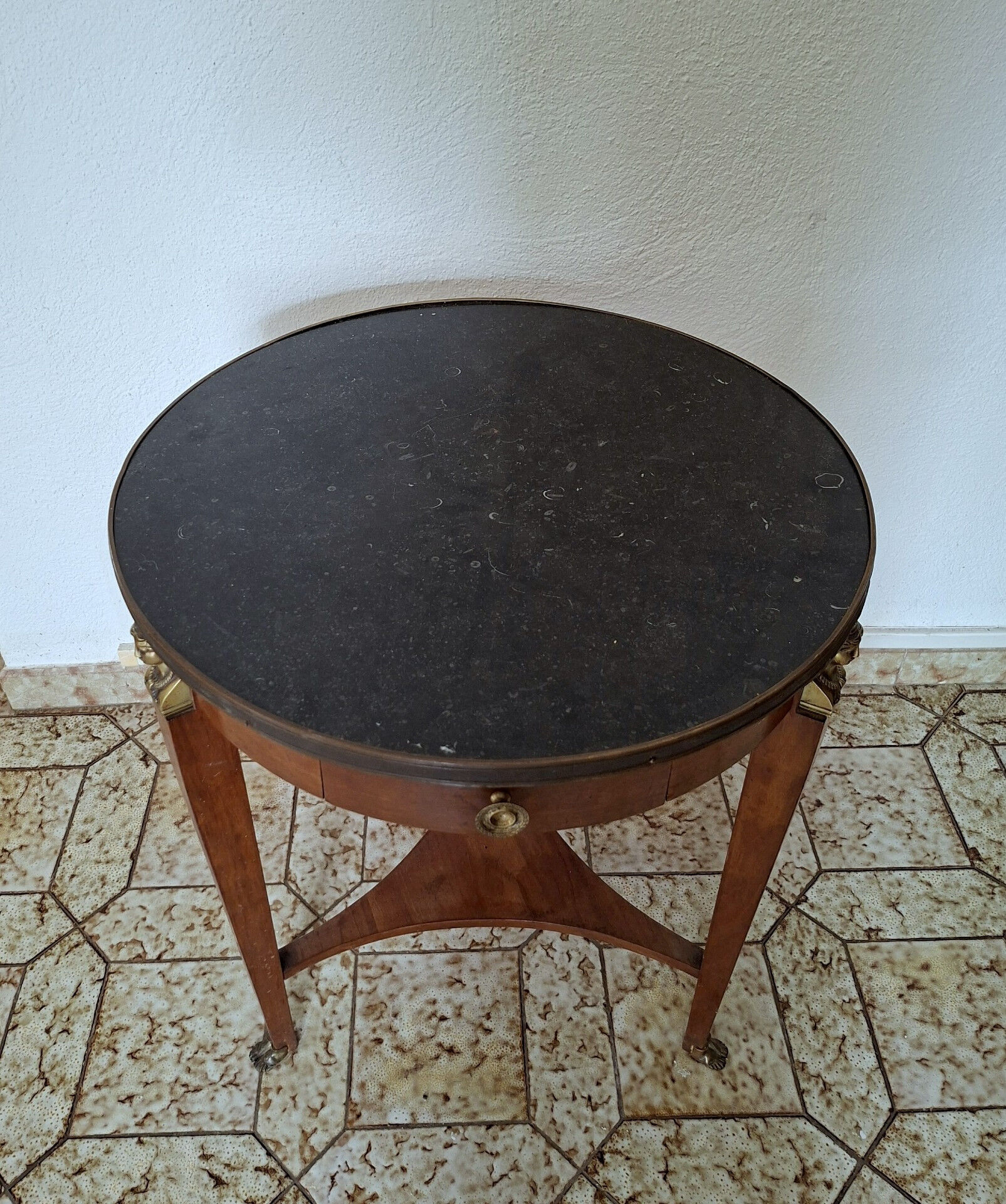 Empire guéridon table in mahogany with a black marble top and gilded bronze.