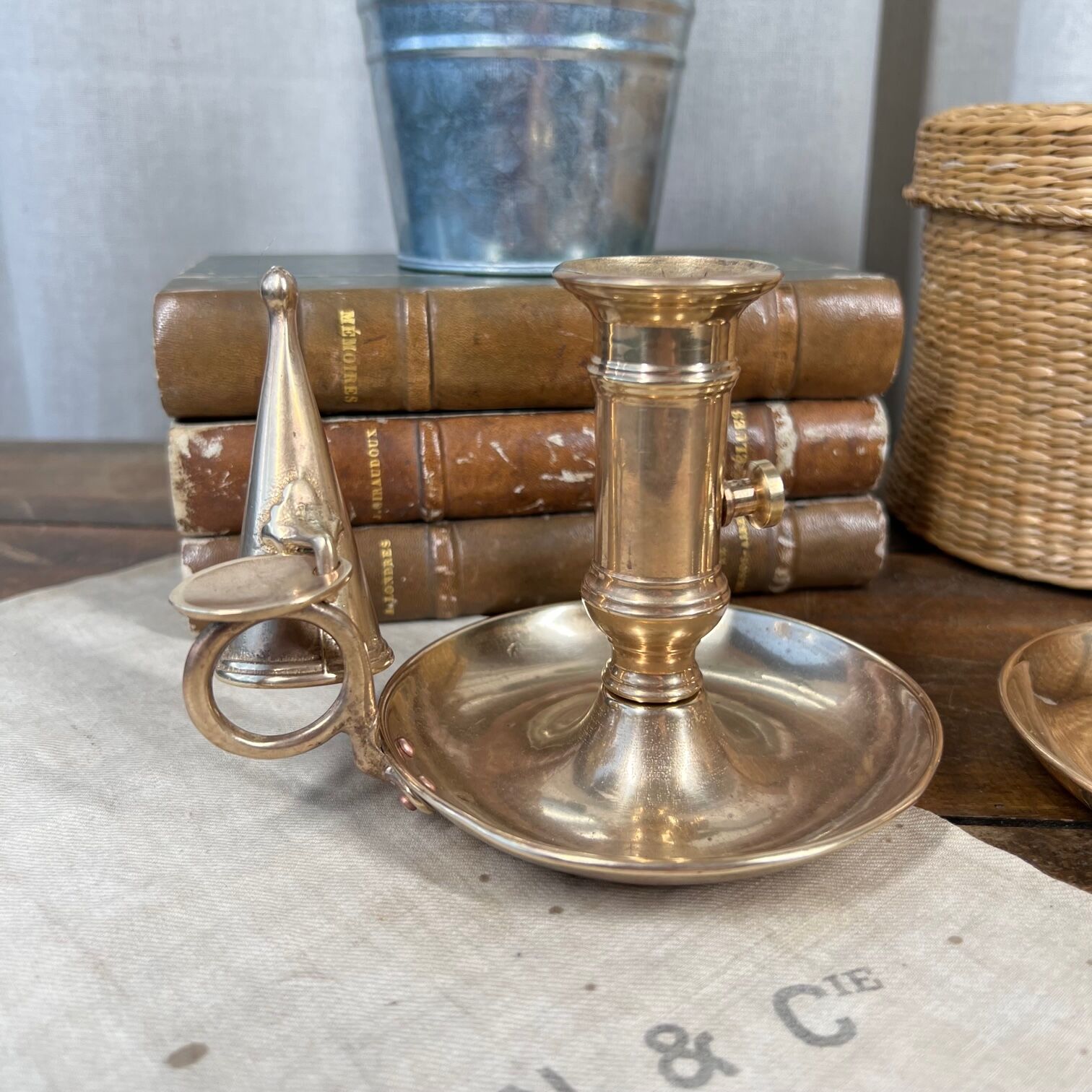 Duo of brass cellar rat candlesticks with extinguisher