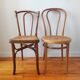 4 mismatched antique bistro chairs in wood and caning