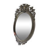 Beveled oval mirror in wood and stucco