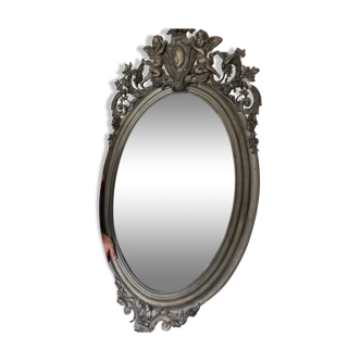 Oval beveled wood and stucco mirror