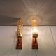 A set of Danish wall lights in champagne coloured glass with brass and teak.