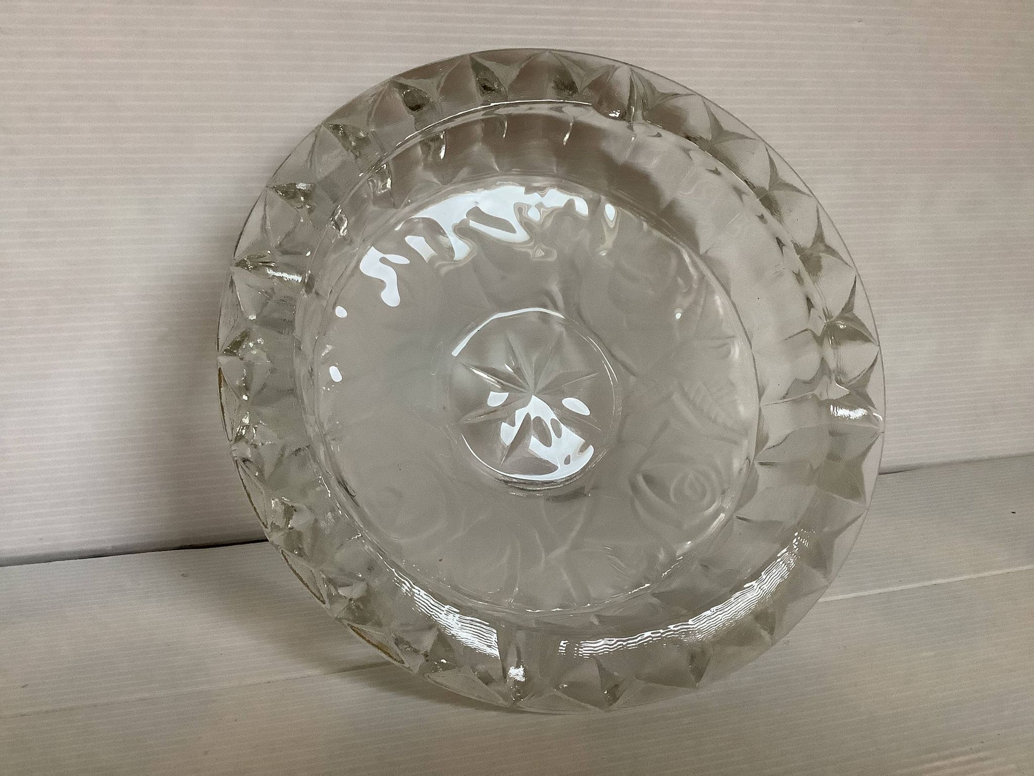Large glass ashtray with frosted flowers.