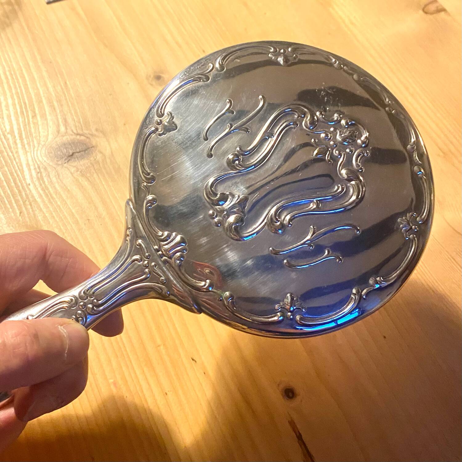 Silver metal hand mirror and laundry brush
