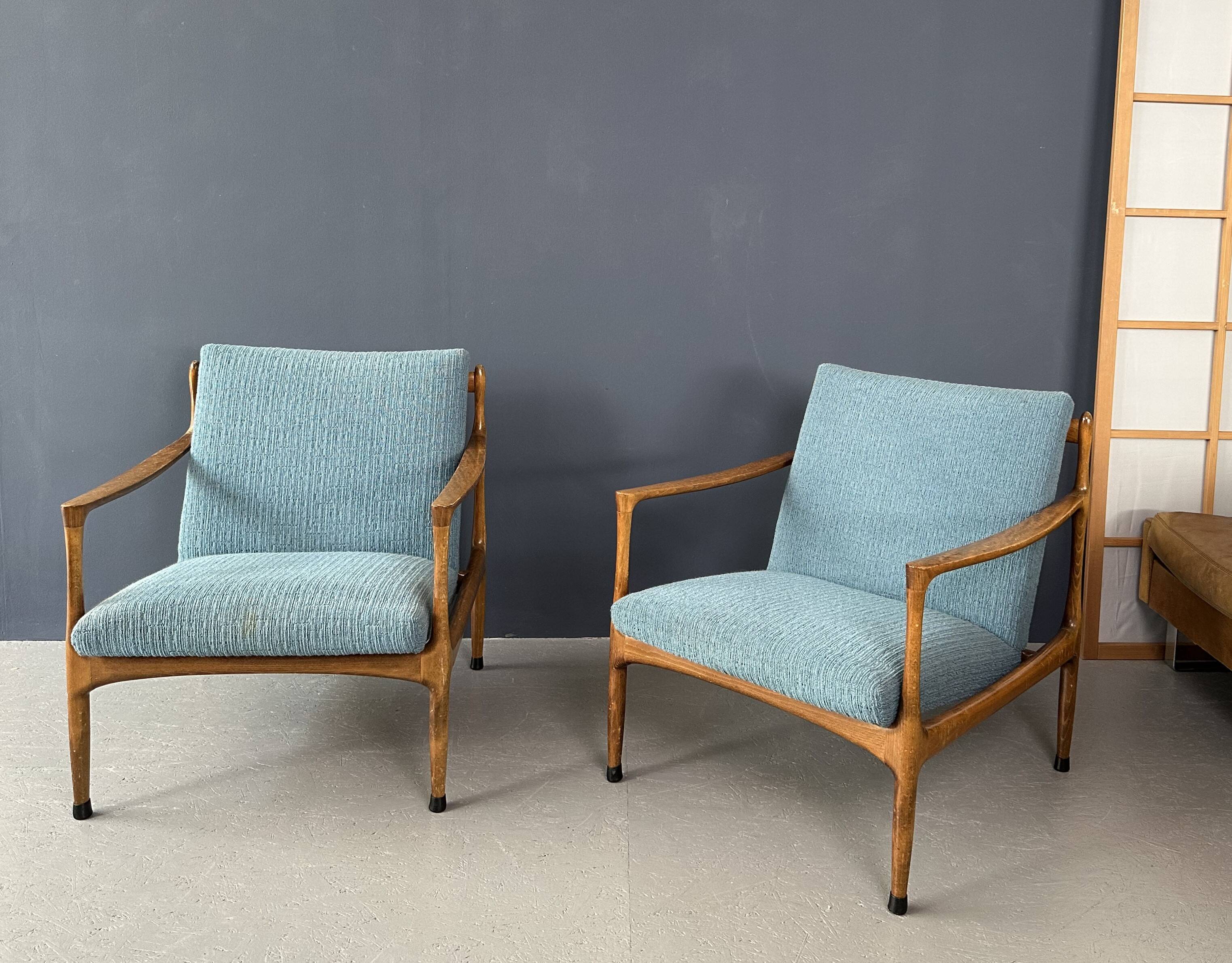 A pair of turquoise armchairs