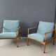 A pair of turquoise armchairs
