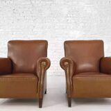 Pair of 1950s club armchairs in imitation leather and wood