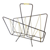Black metal magazine rack with yellow scoubidou wire.