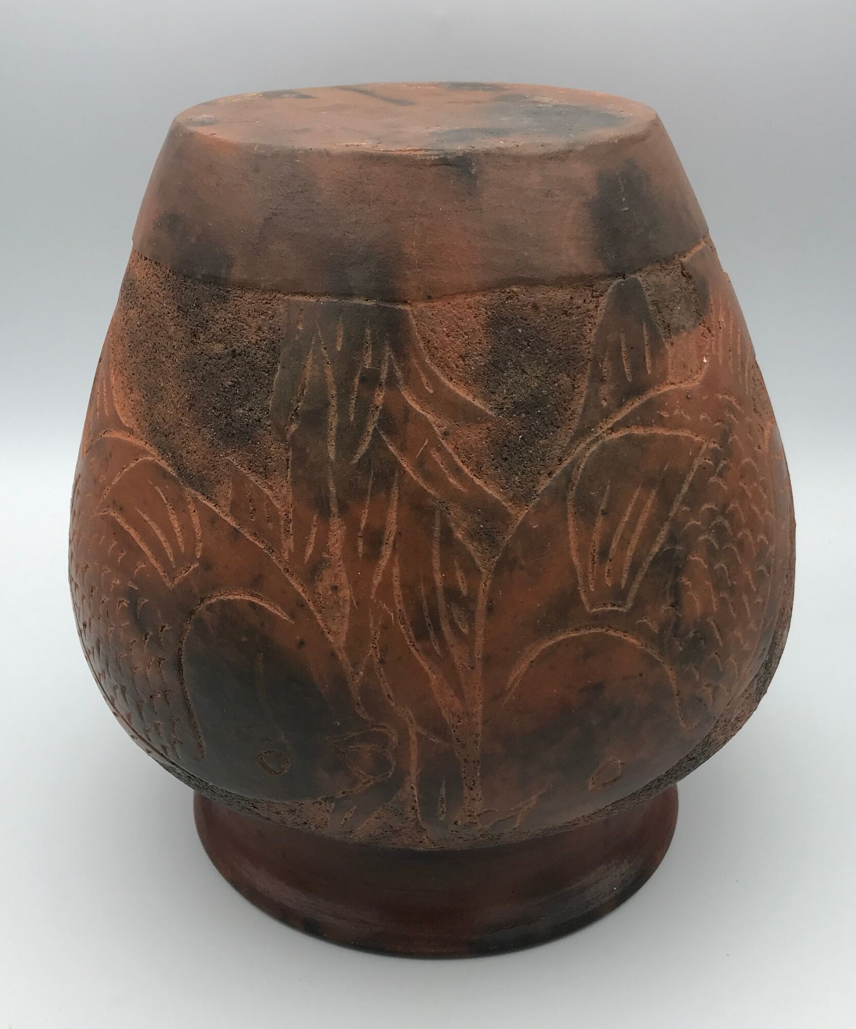 Vase or pot in brown terracotta with artistic decoration of fish.