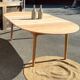 Large round family table with 2 extensions in solid raw wood.