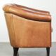 Vintage sheepskin club armchair with a warm colour scheme with black piping