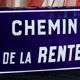Old Enamelled and bulging "Chemin de la Rente" street plate, in perfect condition, on its cast iron support