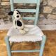 Child's chair in wood and straw revamped in almond green and white.
