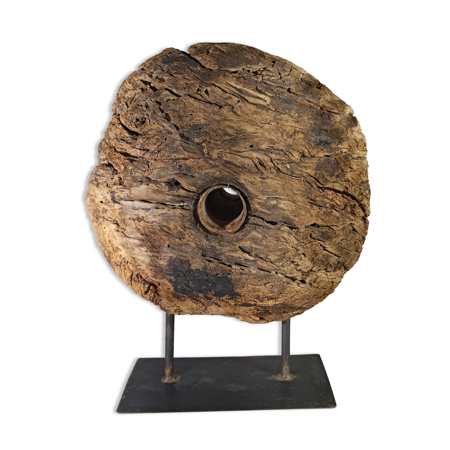 Old wooden pulley wheel on foot