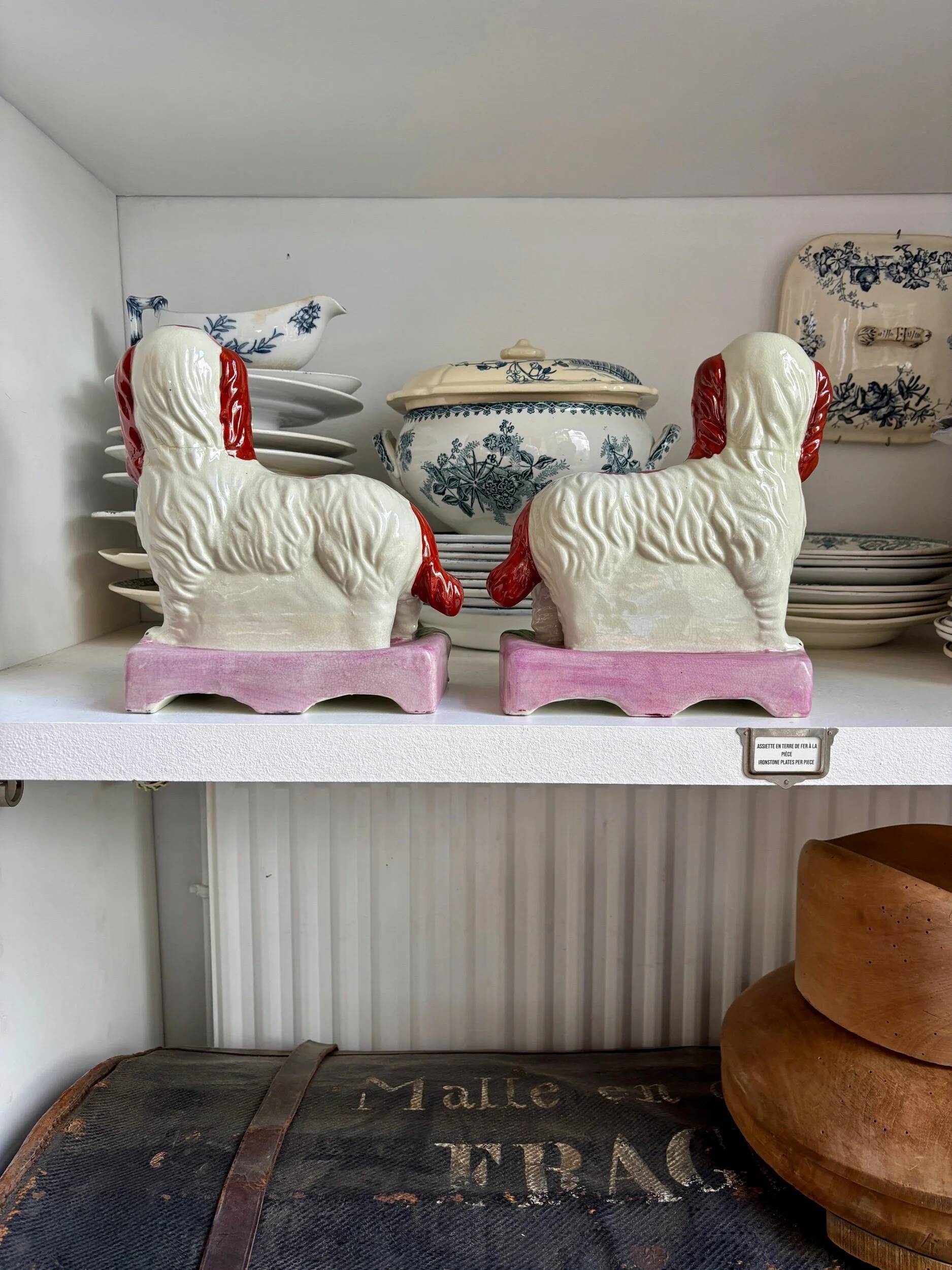 Pair of Staffordshire porcelain Cavalier King Charles dogs on terrace, 19th century.