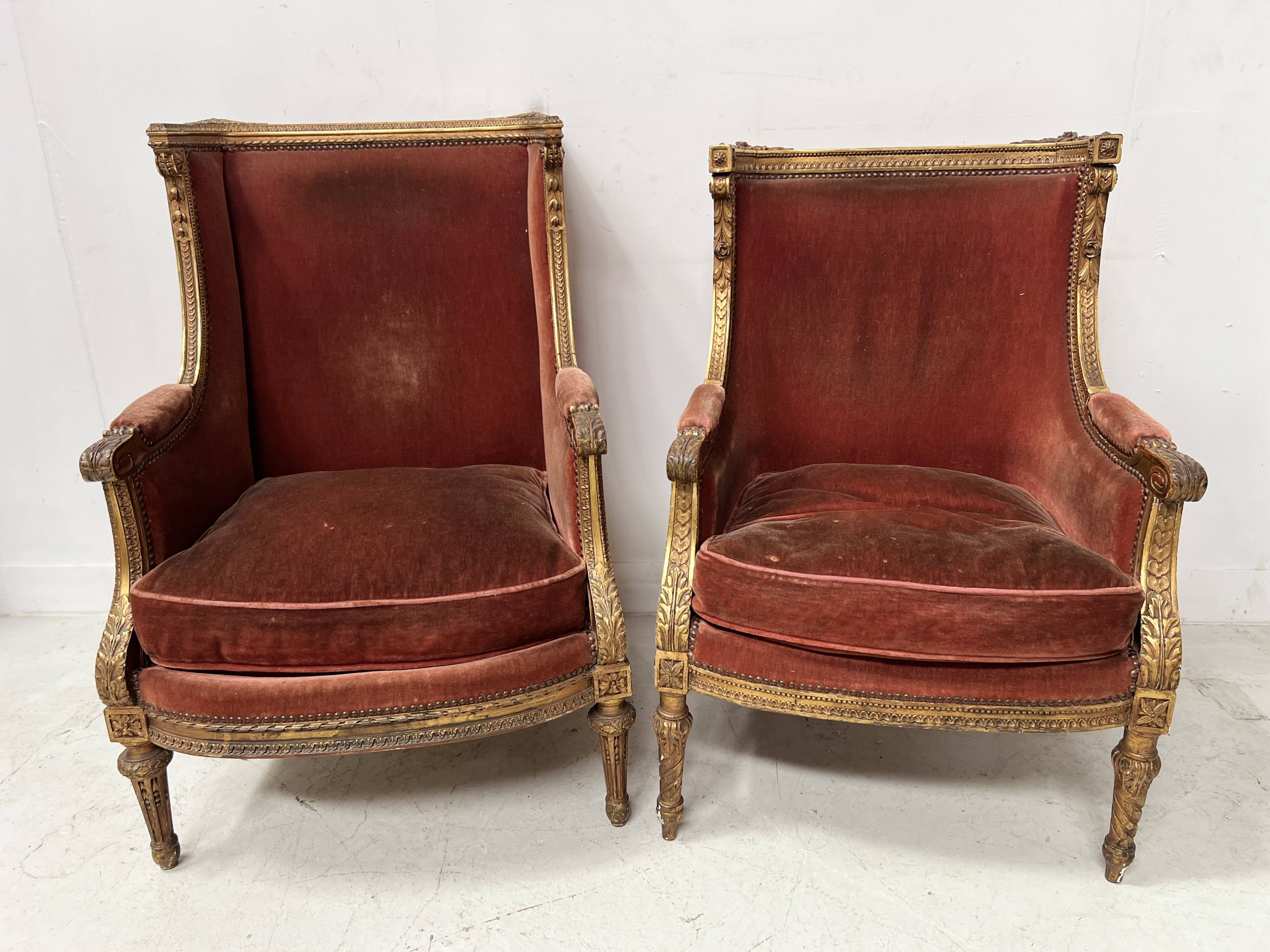 Two Louis XVI style wing chairs in gilded wood, 20th century