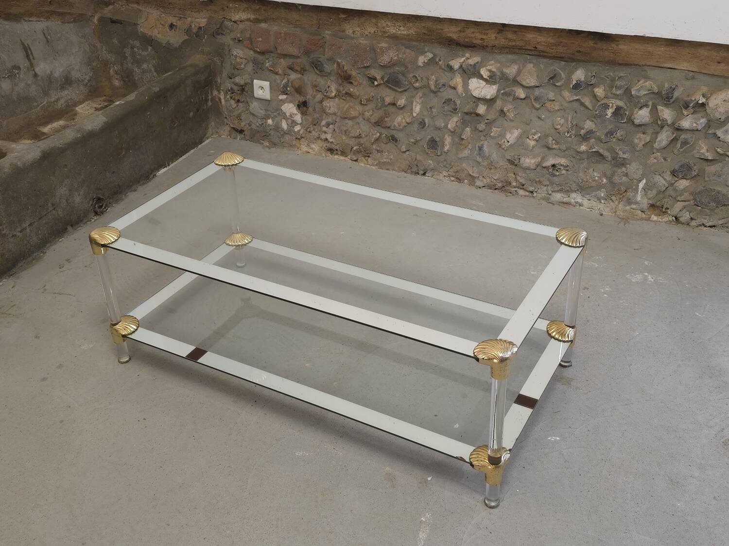 Coffee table, living room table in glass with two tiers, adorned with golden seashells, 1970.