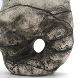 Ceramic vase sculpture decorated with faces and featuring a hole, 1980s.