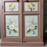 Large antique wardrobe painted with floral decoration.