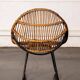 Rattan armchair with metal legs