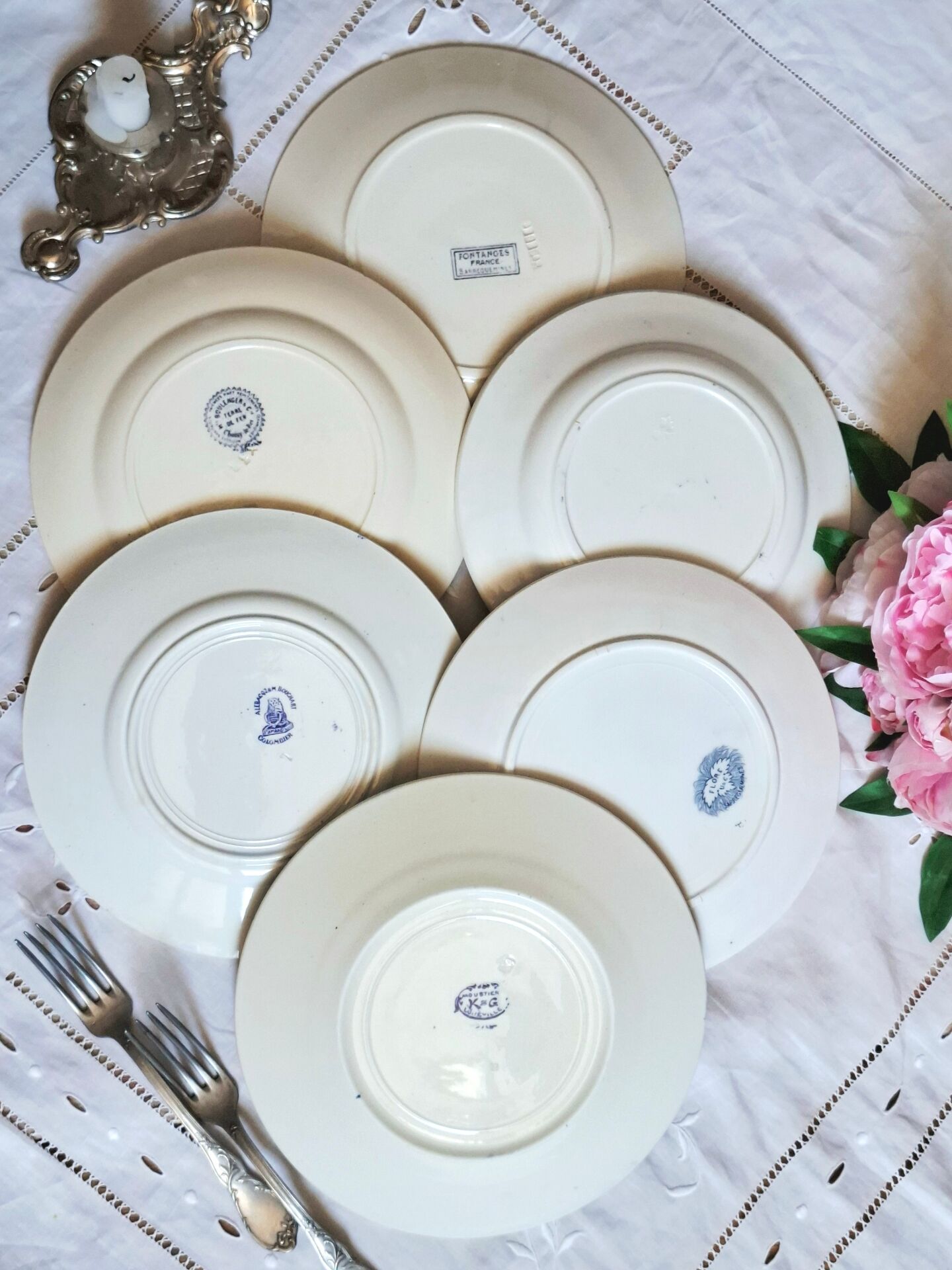 Old mismatched flat plates made of ironstone earthenware.